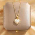 Elegant gold heart pendant necklace with white opal inlay on champagne velvet - LOVE