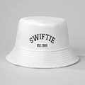 Detailed embroidery of SWIFTIE and EST. 1989 lettering on a white cotton bucket hat - One Size / White