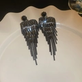 Detailed macro shot of long gun-black tassel earrings with black rhinestones on white plate - Style 3 Silver Post / Gunmetal
