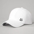 Detail of white cotton baseball cap showing side smile embroidery and fabric texture - Adjustable / White