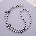 Acrylic heart beads and faux pearl phone strap with silver metal buckles on gray backdrop - Black Heart Crossbody Chain (K2044) / Black
