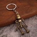 Vintage brass robot keychain with movable joints and silver metal keyring - Bronze