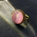 Detail of vintage gold ring featuring a pink cat eye stone and amber micro-pave setting - K-0847 Pink Cat's Eye Open Ring