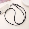 Macro detail of a black woven crossbody phone lanyard with gunmetal spring hook fasteners - Crossbody / Matte Black