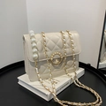 Quilted beige chain crossbody bag with pearl buckle and metal strap on display - Large / Off White