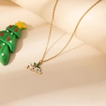 Detailed view of golden NOEL necklace pendant with holly berries on a thin chain - NOEL Letter Leaf Pendant Necklace
