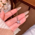Star-shaped silver necklace with micro-paved zircons held in hand for detailed view - Hollow Pentagram Pave Style (X2005) / Silver/Star Pendant