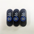 Three oval LED modules for smart bracelets showing blue digital time on a white surface - Mi 4 Blue Ring White LED
