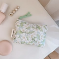 Detail of floral quilted cotton pouch with green zipper pull and simple wish woven label - Green Gardenia