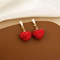 Macro detail of red heart earrings with gold base and faceted crystals on silk - Red Heart Full Rhinestone Dangle
