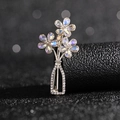 Detailed view of silver flower vase brooch with sparkling crystals on black surface - Three Crystal Flowers Brooch