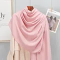 Detail of pink cotton linen scarf draped elegantly on a beige blazer and wooden hanger - Pink