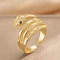 Adjustable gold snake ring with sparkling zircon stones and green gemstone eyes - Gold
