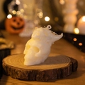 White skull-shaped double-layered candle on rustic wood for Halloween decor - Horned Skull / White