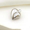 Detailed macro shot of a polished silver heart pendant with reflective metallic surface - Silver Heart