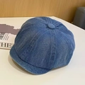 Detailed view of blue denim newsboy cap with classic panel stitching and top button detail - Mid Blue Short Brim Newsboy Hat