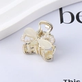 Macro detail of a golden butterfly hair claw clip with rhinestones and faux pearls - 10# Pearl Bow Claw Clip