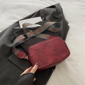 Burgundy rectangular crossbody bag featuring floral embossing and a retro wide strap - Red