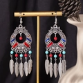 Detail view of Bohemian tassel earrings with enamel pattern and blue beads on a gold T-stand - S4291-2 Colorful Leaf Fringe Earrings