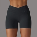 Detail of black seamless yoga shorts featuring a crossover V-waistband and ribbed fabric - S / Bottoms / Black