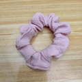 Pink scrunchie hair tie with soft pleated texture on natural light wood background - Small / Pink