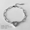 Silver stainless steel paperclip chain bracelet featuring a hollow heart charm detail - Hollow Heart Pendant Paperclip Chain (XBL0040-1)