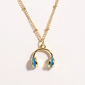 Close-up of golden headphone pendant with blue enamel on a bead chain necklace - Blue Headphones
