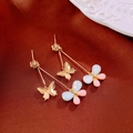 Detailed macro view of asymmetric bow tassel earrings with pink and blue gemstones - Pink Blue Asymmetric Butterfly (7#)