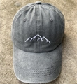 Smoky grey washed cotton baseball cap featuring white mountain embroidery on the front - Light Gray