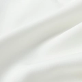 Macro shot of high-quality white textile fabric with fine weave and soft shadow folds - S / White