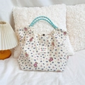 Detail of floral pattern bear print tote bag with woven rope handles on bed - Purple Flower Toy Bear