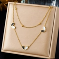 Detail showing double-layered gold-plated chain with black and white heart pendants - Black and White Heart Necklace (N4075)