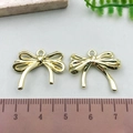Golden metal hollow bow pendant charm measured with ruler showing 3-4cm width size - Double Layer Hollow Bowknot - KC Gold (21406)