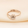 Detail of rose gold cat paw ring with sparkling cubic zirconia on beige silk - US 6
