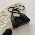 Elegant black handbag with large satin bow accent and adjustable shoulder strap - Black