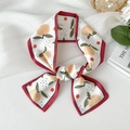 Elegant narrow silk scarf with orange fruit and green leaf print tied in a bow - Red Border Orange
