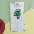 Green number 4 dinosaur birthday candle with white dots and back fin for kids' parties - Green Dinosaur Number 4