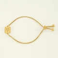 Adjustable gold titanium steel bracelet featuring a frosted square charm with letter U - Letter U / Gold