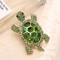 Vintage golden turtle brooch with faceted green gemstone and emerald rhinestones - Turtle Shape / Green