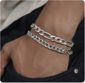 Close-up of silver stainless steel Cuban and Figaro link bracelets on wrist - Style 5