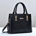 Elegant black quilted tote bag with golden hardware and adjustable crossbody strap - Black