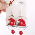 Festive Christmas hat hoop earrings with snowflake charm and red beads on display - Hoop Christmas Hat