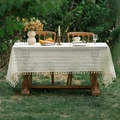 Close-up of beige lace tablecloth with hollow floral patterns and handmade tassels - Polka Dot Flower with Tassels