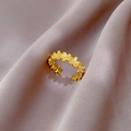Detailed close-up of a gold flower ring with sparkling white zircons on purple fabric - Adjustable Open / Gold Plated Flower Style (J0065)