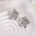 Large silver floral stud earrings with textured petals on minimalist display stand - Hammered Wrinkle / Silver