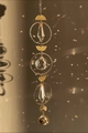 Golden suncatcher with crystal prisms and sun face pendant creating rainbow light spots - Sun Style