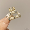 Detail shot of a 2.5cm golden metal hair claw clip with pearls and rhinestones - Semicircle Mixed Decor