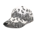 Detail view of white baseball cap with intricate black paisley patterns and curved brim - M (56-58cm) / White