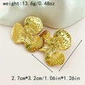 Detail of gold floral earrings with hammer-textured petals and sparkling rhinestone centers - Hammered Zirconia Flower / Gold