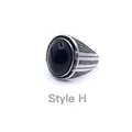 Detailed macro shot of vintage mens ring featuring black gemstone and silver textured metal - Style H